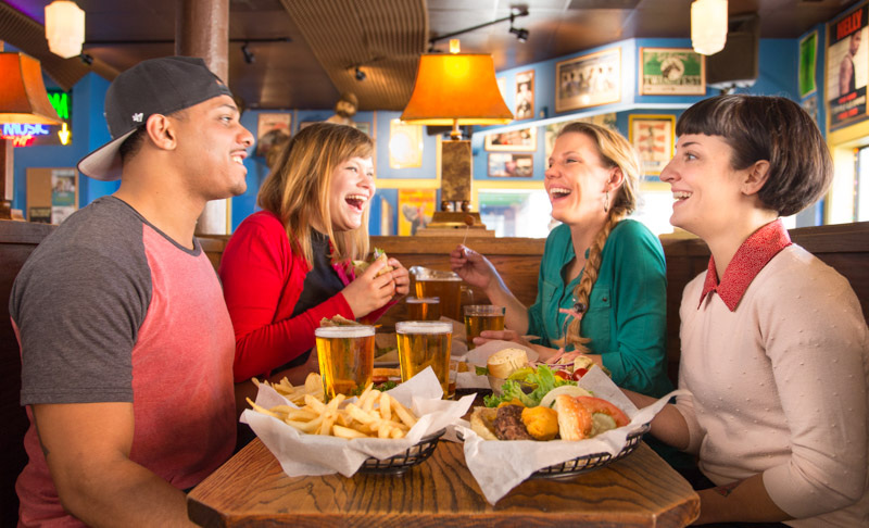 Friends enjoying great food in Piano Room
